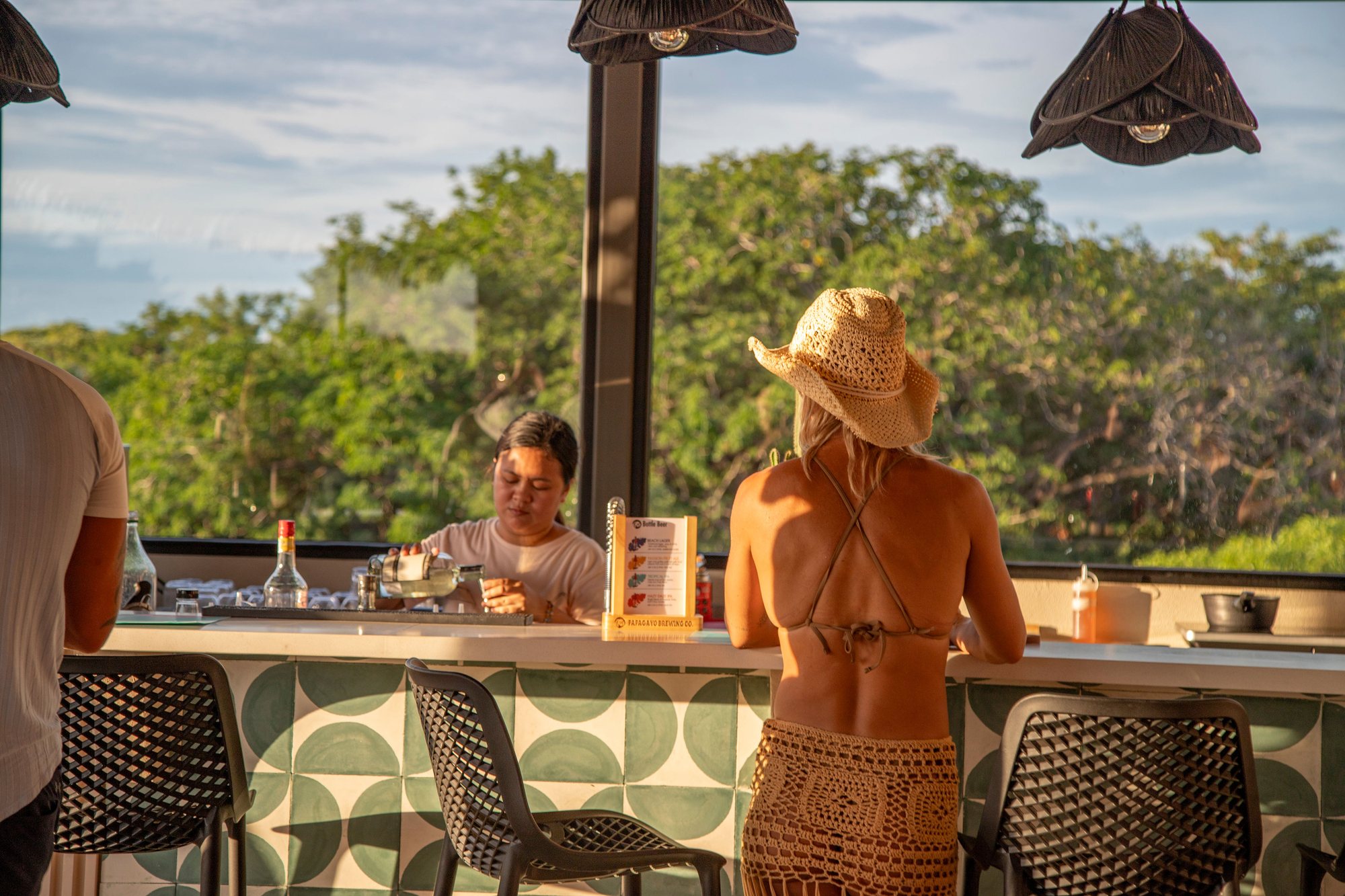 Guests at Naia's bar during golden hour