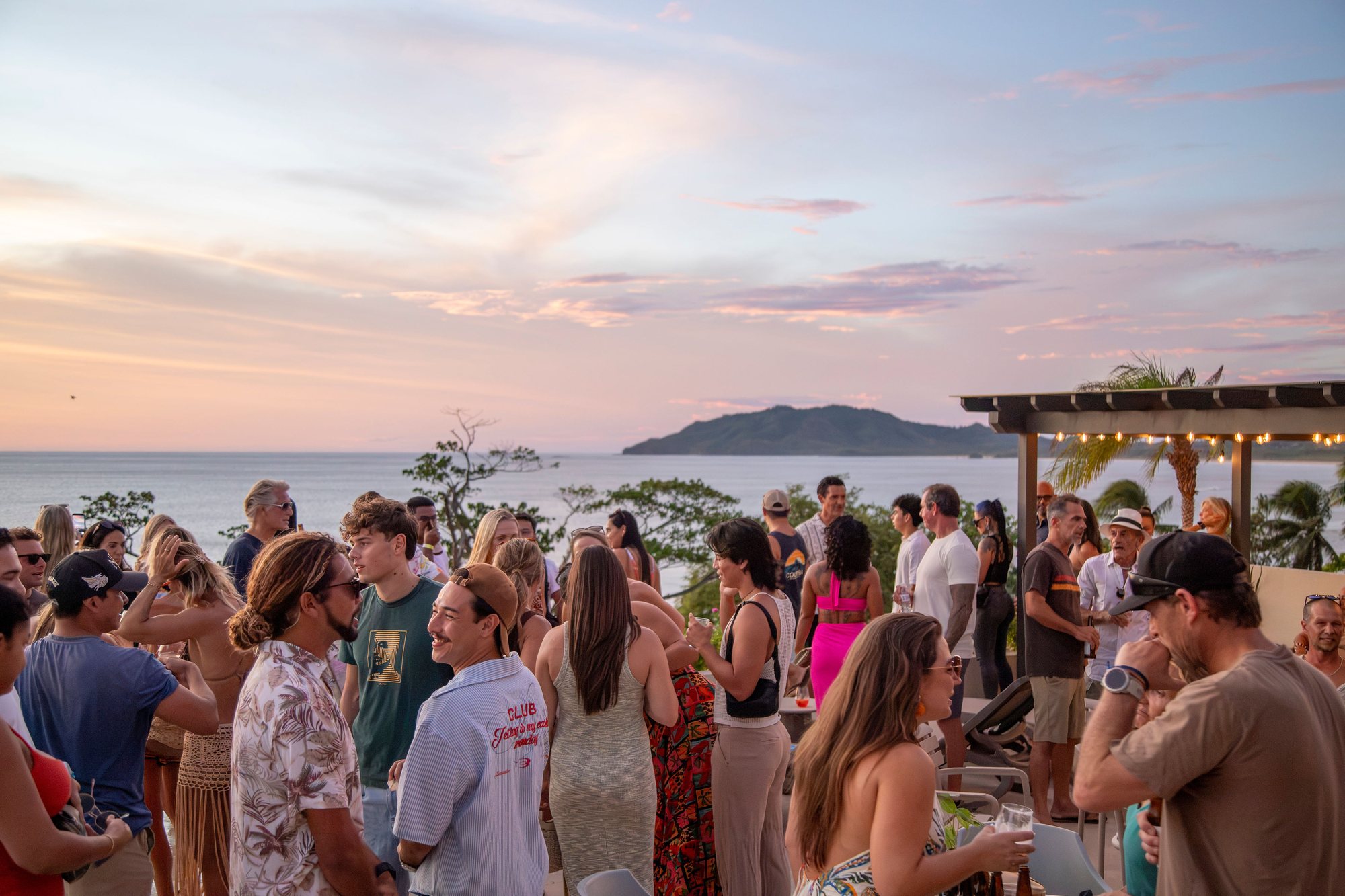 Guests gathered on the rooftop at sunset