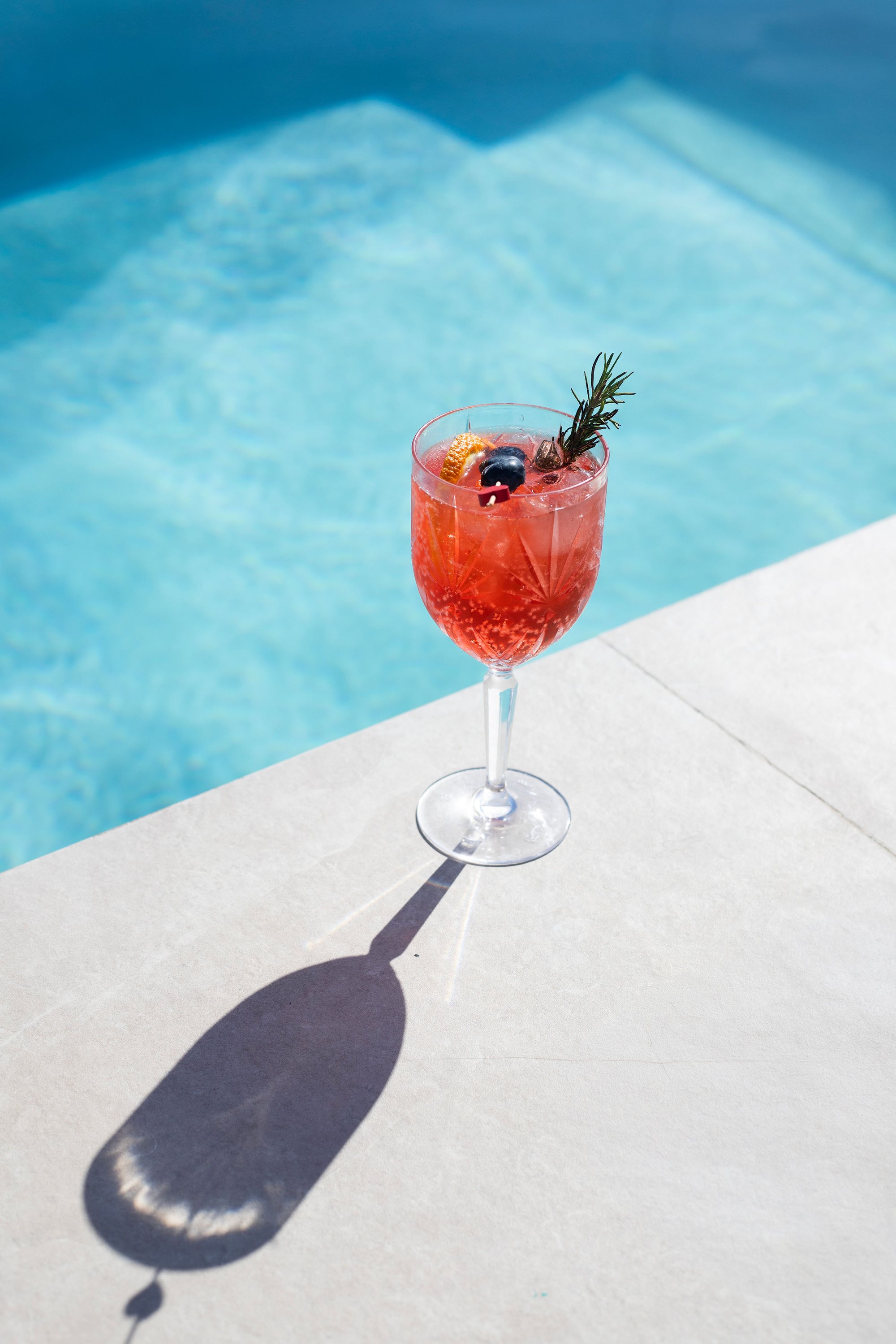 A spritz cocktail beside the rooftop pool
