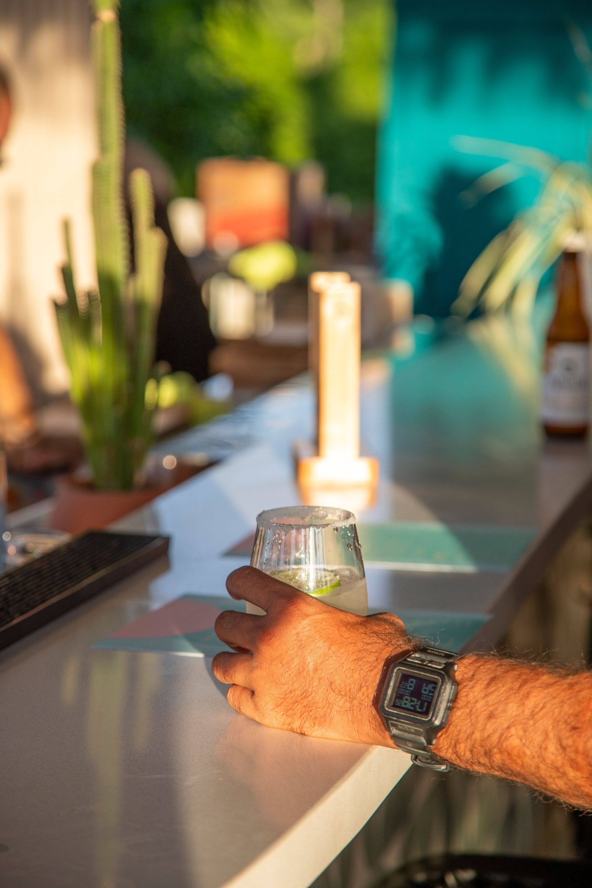 A drink in hand as dusk settles over the rooftop