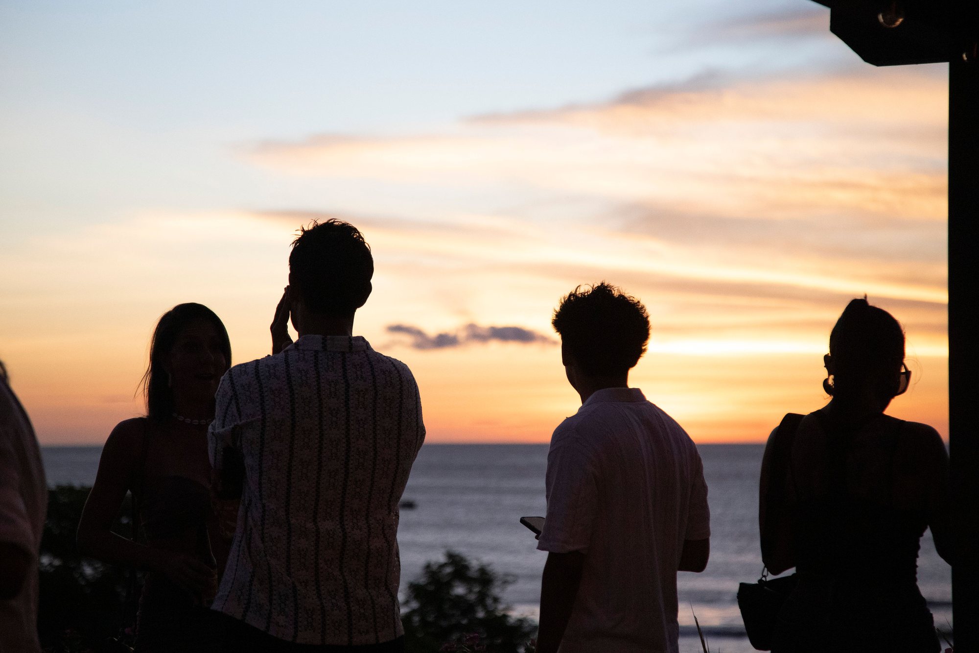 Guests silhouetted against the sunset